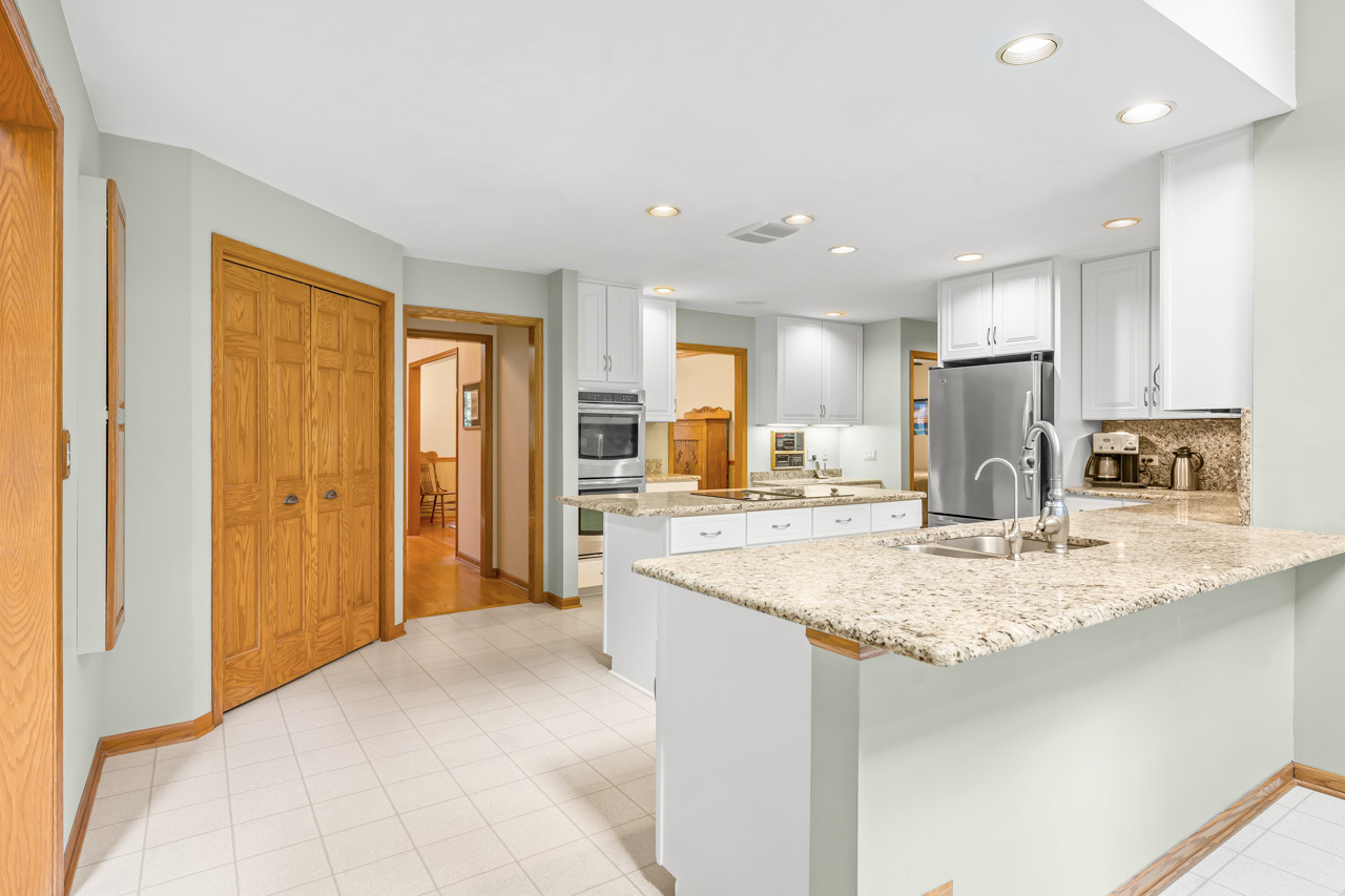 31W139 Rohrssen Road Hoffman Estates, IL 60192 - Photo 21 of 51 a kitchen with stainless steel appliances granite countertop sink refrigerator and cabinets