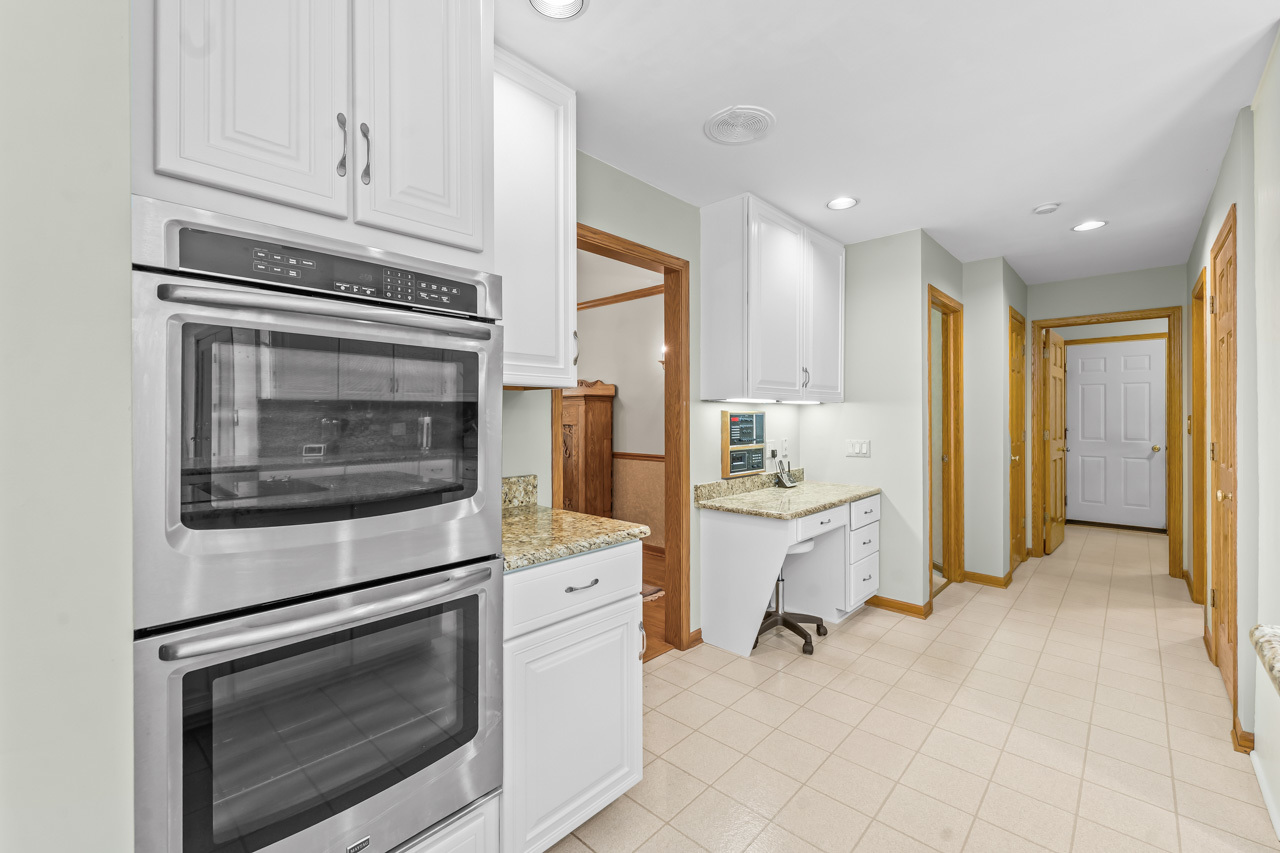 31W139 Rohrssen Road Hoffman Estates, IL 60192 - Photo 24 of 51 a kitchen with granite countertop cabinets and steel stainless steel appliances