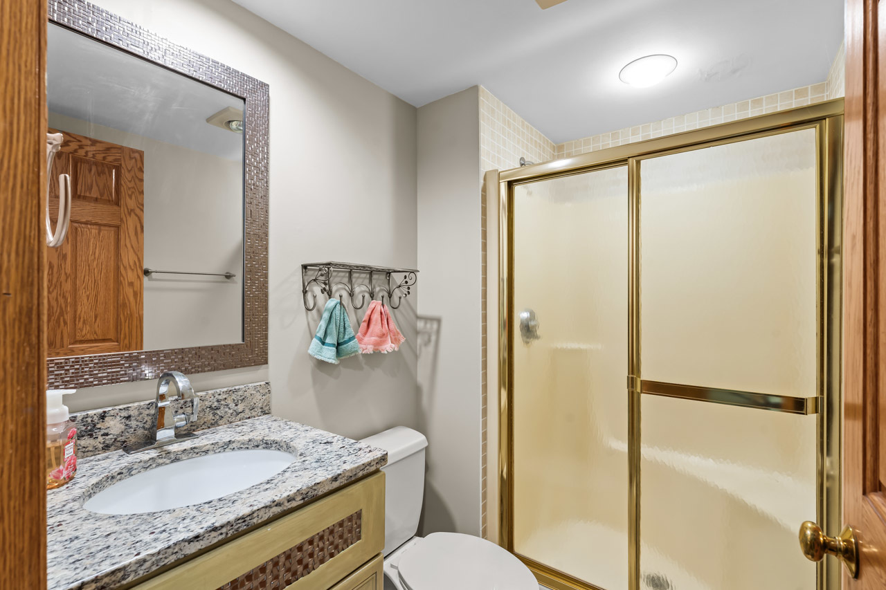 31W139 Rohrssen Road Hoffman Estates, IL 60192 - Photo 28 of 51 a bathroom with a granite countertop sink toilet and shower