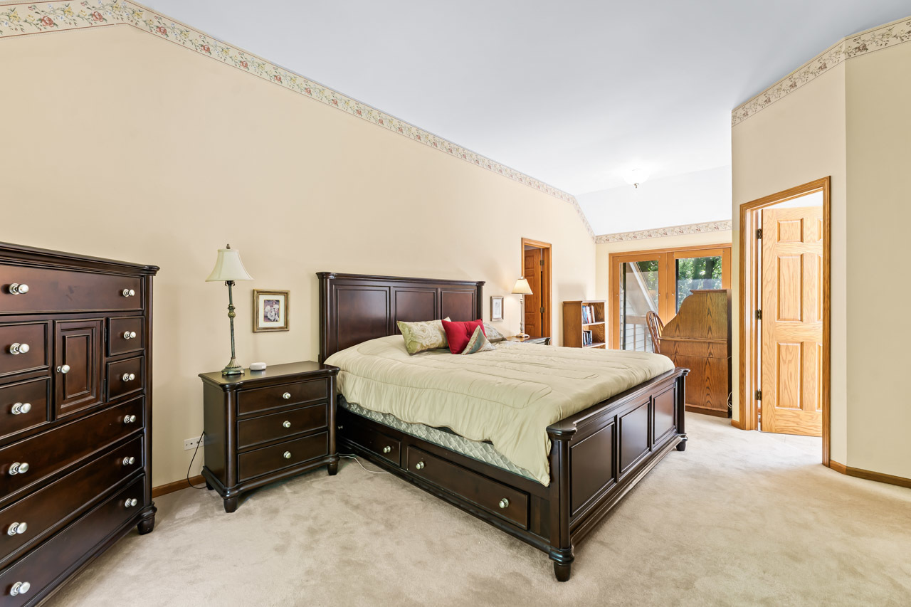 31W139 Rohrssen Road Hoffman Estates, IL 60192 - Photo 31 of 51 a spacious bedroom with a bed and a dresser