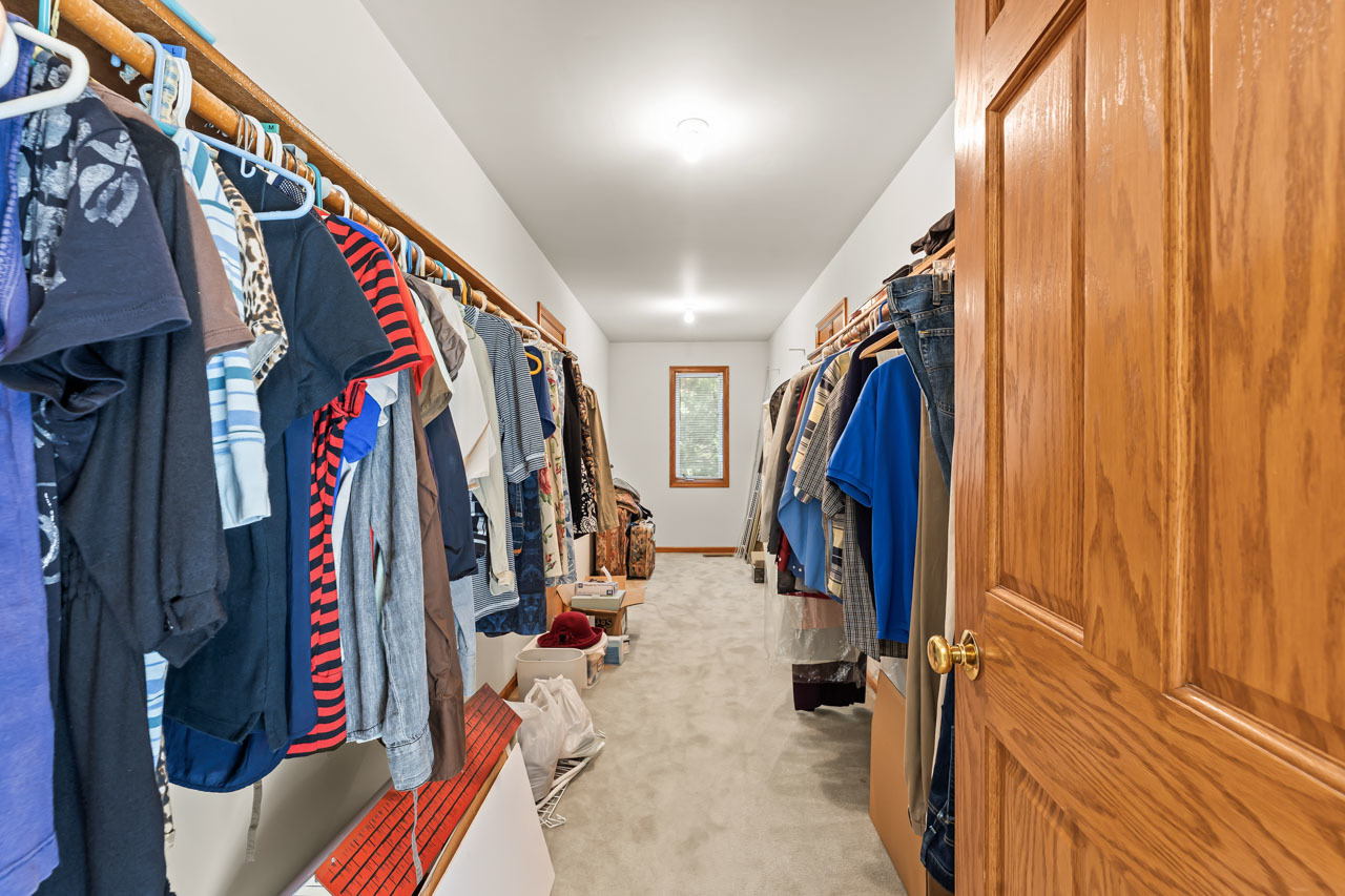 31W139 Rohrssen Road Hoffman Estates, IL 60192 - Photo 33 of 51 a view of walk in closet with clothes and shoes