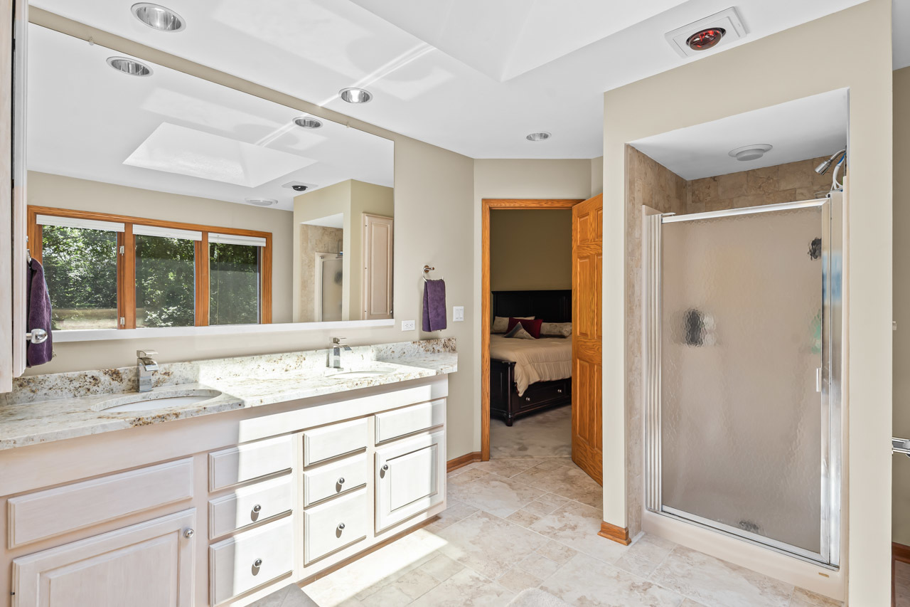 31W139 Rohrssen Road Hoffman Estates, IL 60192 - Photo 35 of 51 a spacious bathroom with a granite countertop sink mirror and shower