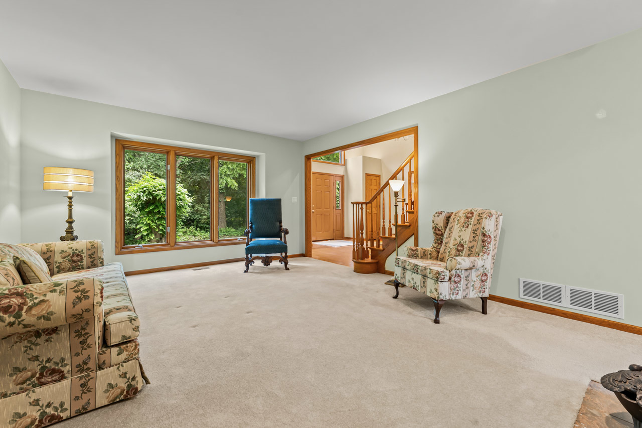 31W139 Rohrssen Road Hoffman Estates, IL 60192 - Photo 7 of 51 a living room with furniture and a large window
