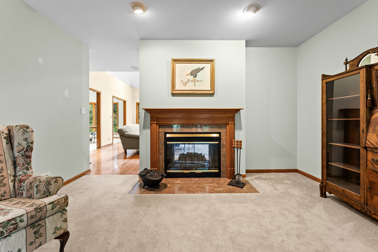 31W139 Rohrssen Road Hoffman Estates, IL 60192 - Photo 8 of 51 a living room with furniture and a fireplace