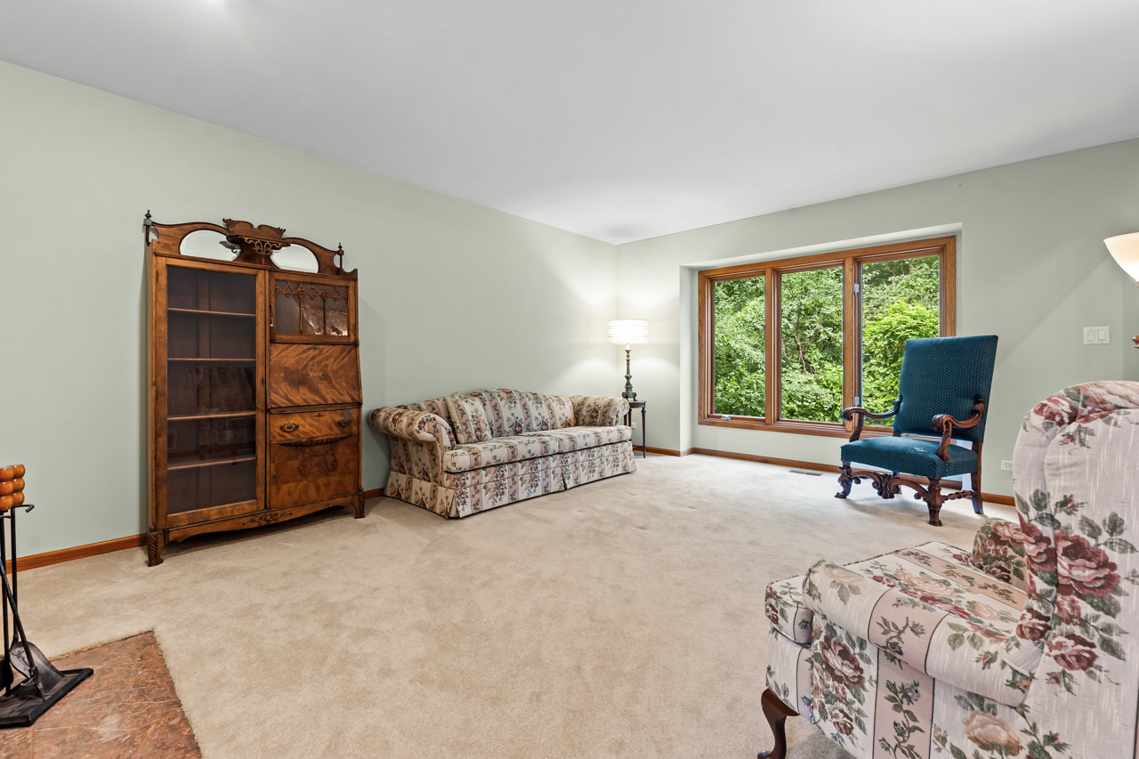 31W139 Rohrssen Road Hoffman Estates, IL 60192 - Photo 9 of 51 a living room with furniture and a flat screen tv