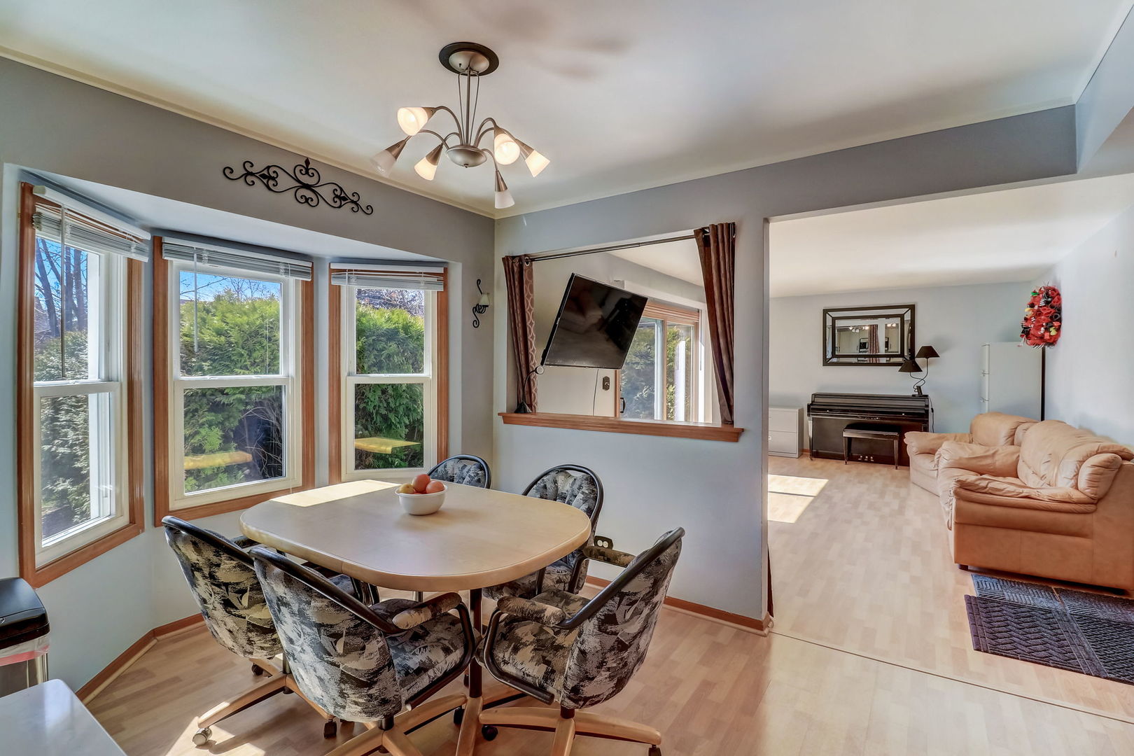 331 Sutcliffe Circle Vernon Hills, IL 60061 - Photo 6 of 26 a living room with furniture a chandelier and a dining table