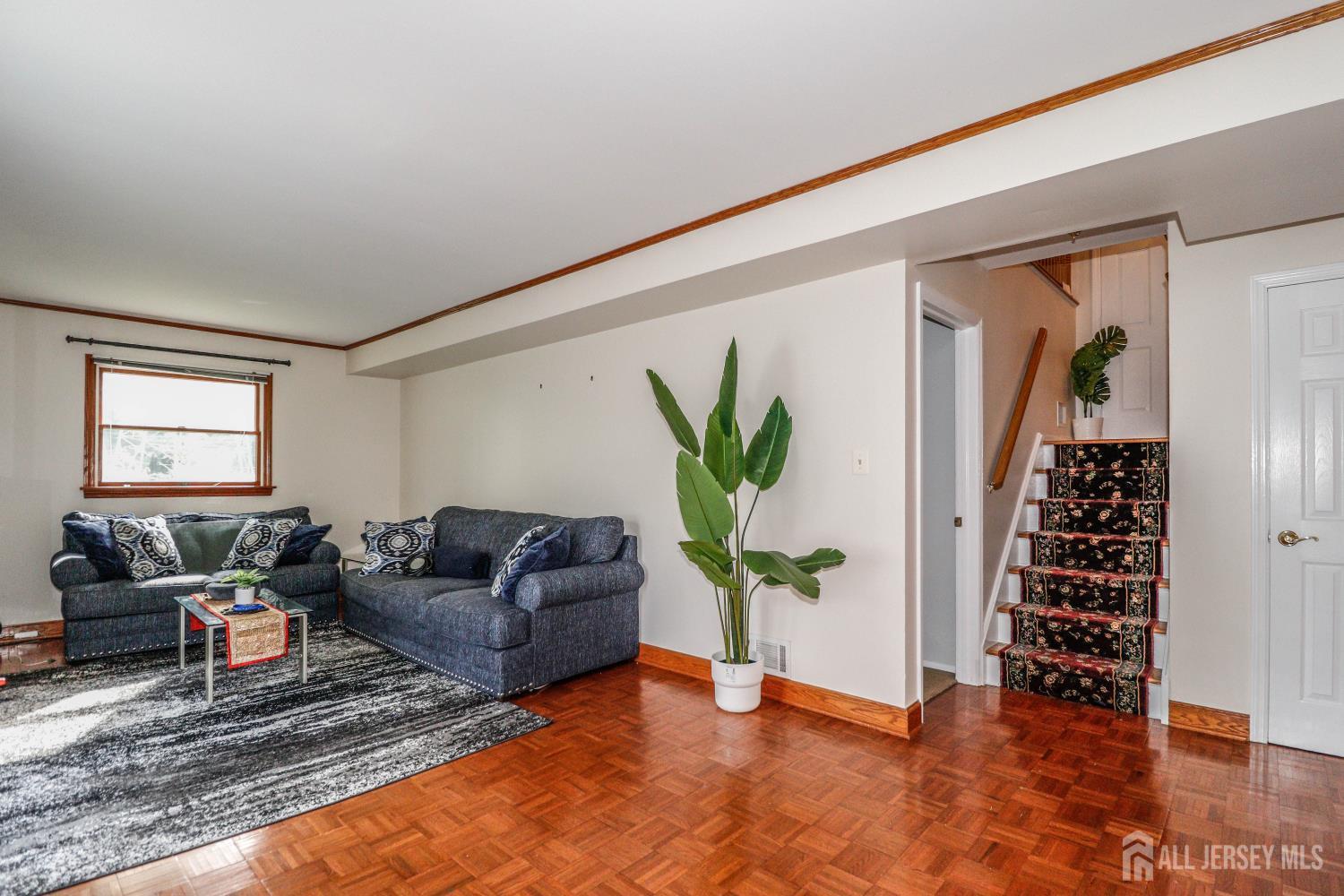 5 Timothy Court Edison, NJ 08837 - Photo 25 of 32 a living room with furniture and a potted plant