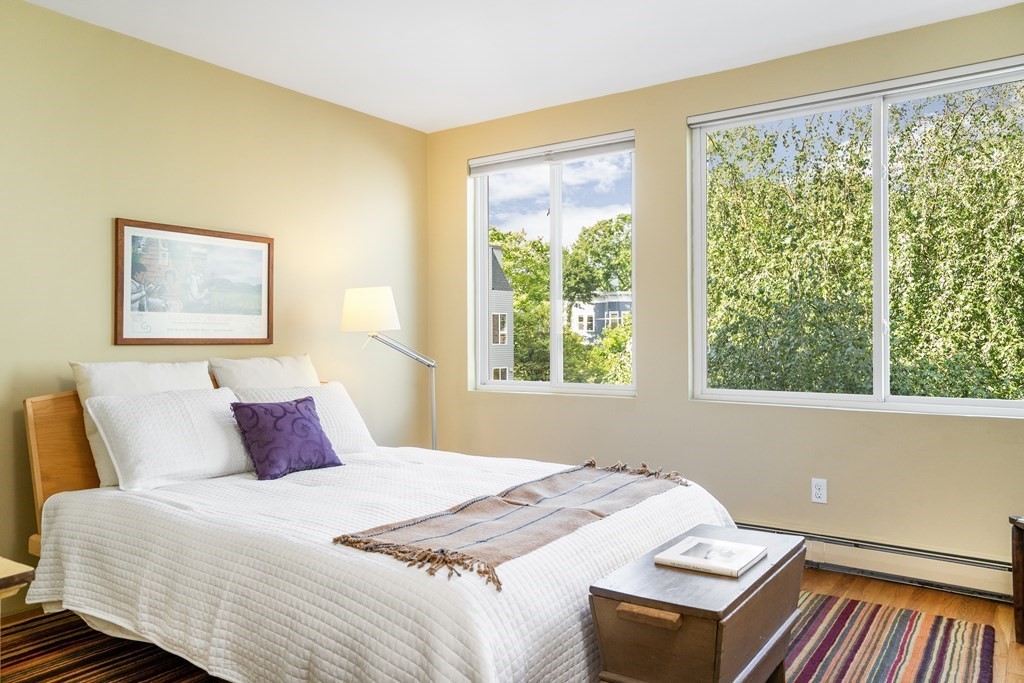 4 Ellery Square Cambridge, MA 02138 - Photo 12 of 23 a bedroom with a bed and wooden floor