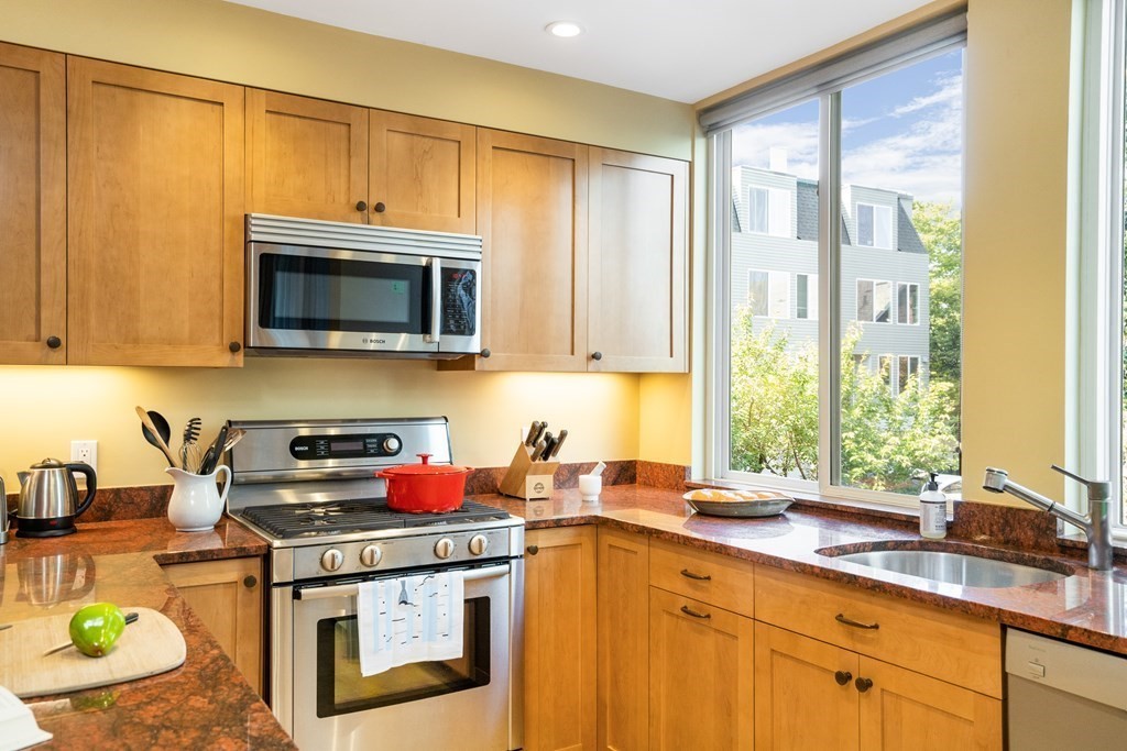 4 Ellery Square Cambridge, MA 02138 - Photo 9 of 23 a kitchen with a stove a sink and a microwave
