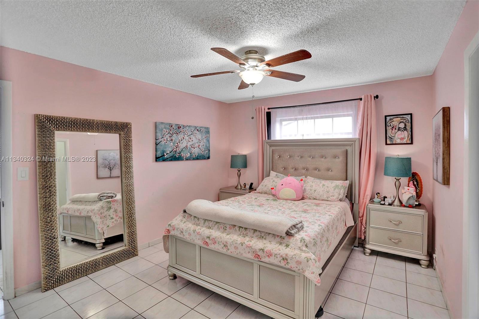 2574 West 71st Place Hialeah, FL 33016 - Photo 14 of 48 a bedroom with a bed and a chandelier