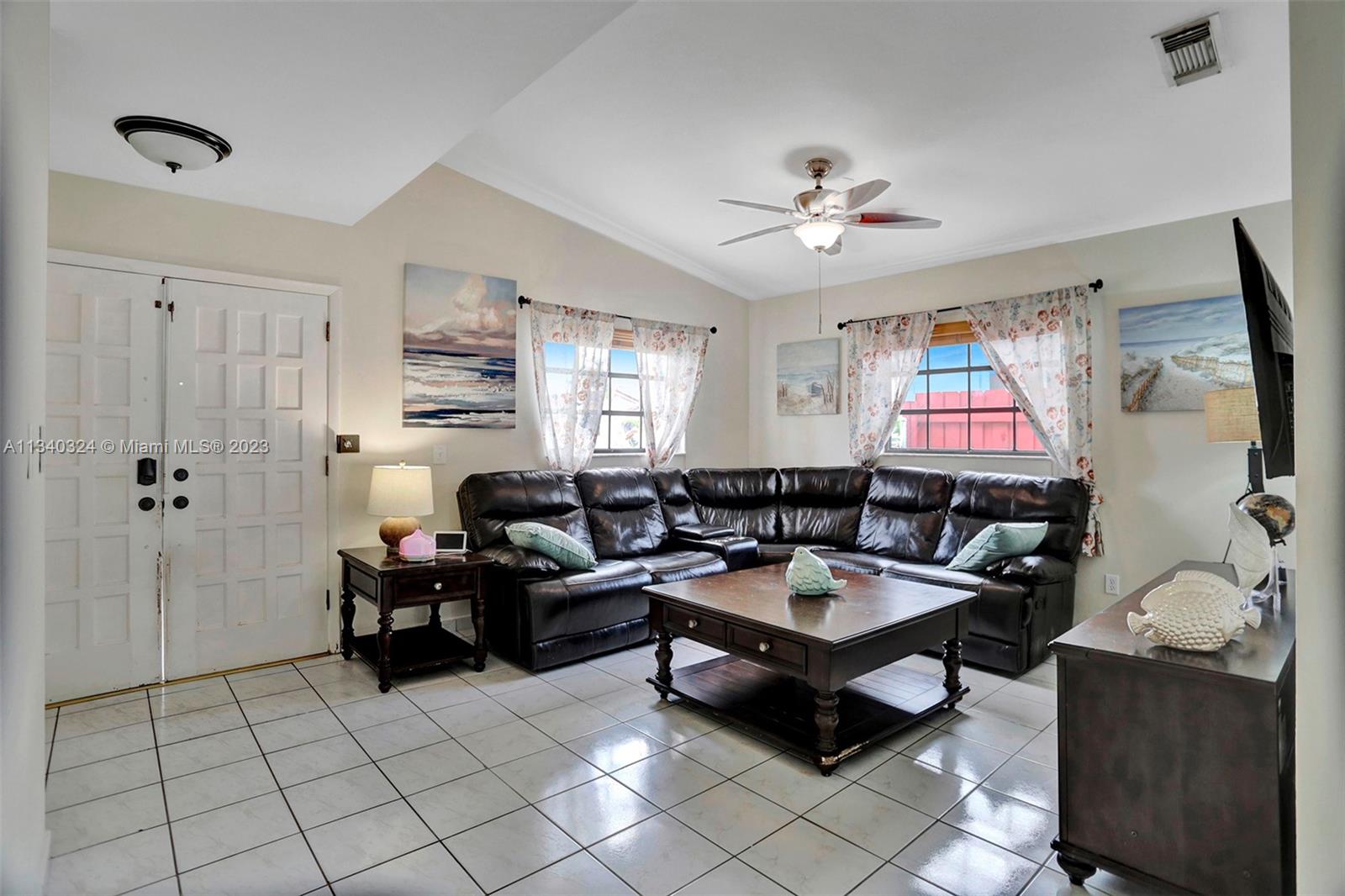 2574 West 71st Place Hialeah, FL 33016 - Photo 20 of 48 a living room with furniture and a chandelier