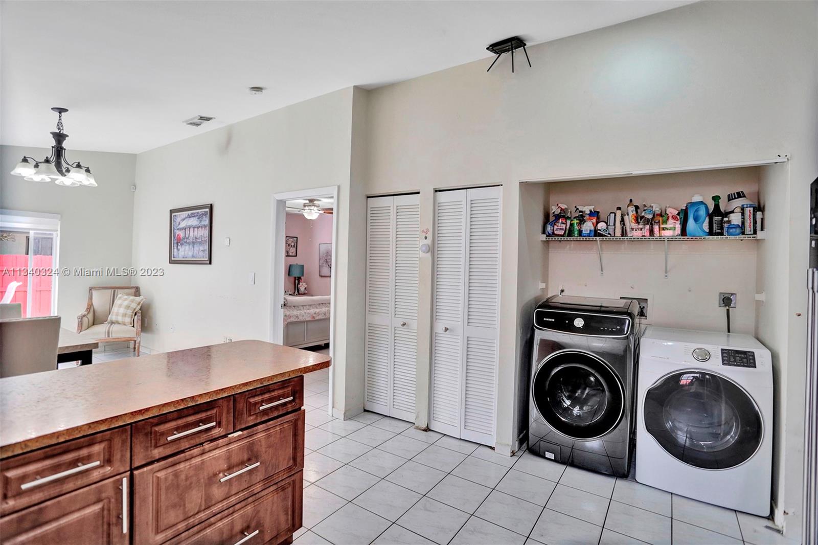 2574 West 71st Place Hialeah, FL 33016 - Photo 27 of 48 a view of a storage and utility room with washer and dryer