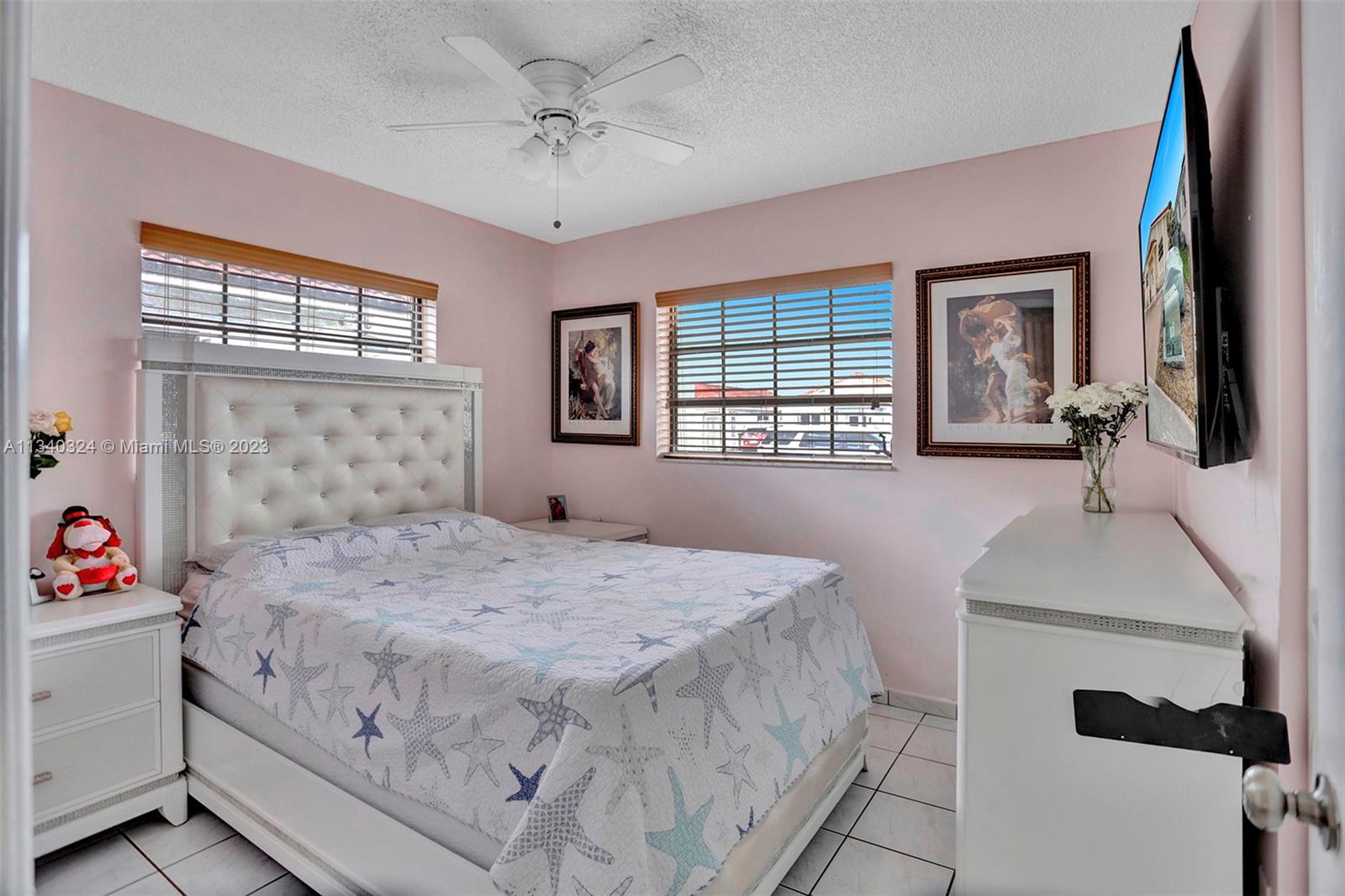 2574 West 71st Place Hialeah, FL 33016 - Photo 42 of 48 a bedroom with a bed and a dresser next to a window