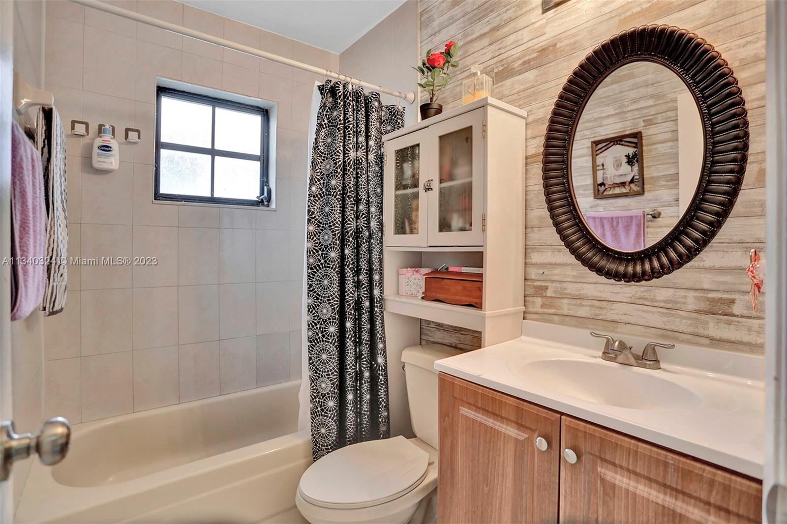 2574 West 71st Place Hialeah, FL 33016 - Photo 6 of 48 a bathroom with a sink a toilet and a shower