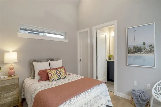 a bedroom with a bed and a painting on the wall