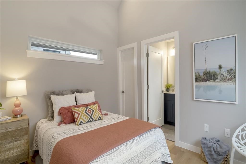 1118 Stobaugh Street, Unit B Austin, TX 78757 - Photo 3 of 12 a bedroom with a bed and a painting on the wall
