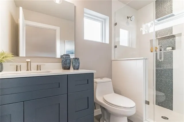 a bathroom with a toilet a sink and a mirror