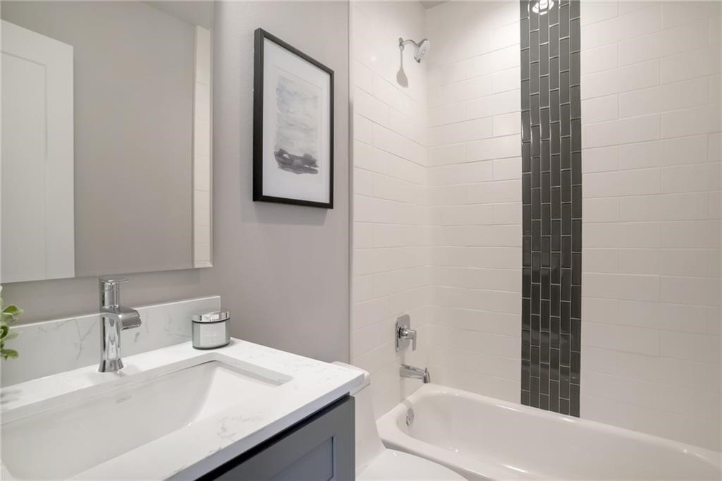 1118 Stobaugh Street, Unit B Austin, TX 78757 - Photo 7 of 12 a bathroom with a sink a toilet and shower