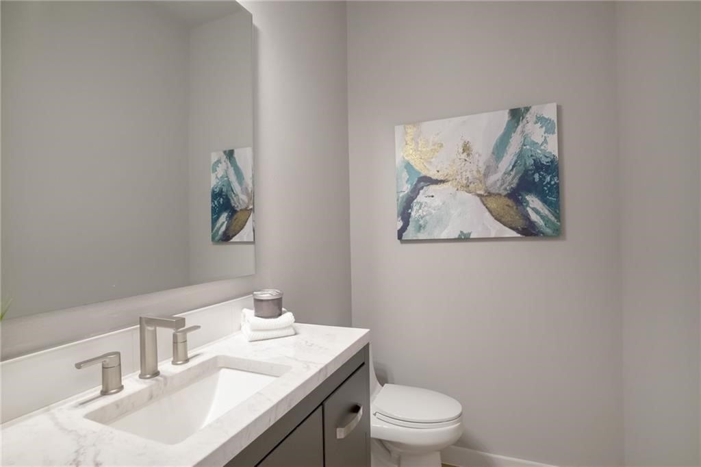 1118 Stobaugh Street, Unit B Austin, TX 78757 - Photo 8 of 12 a bathroom with a granite countertop sink mirror and toilet