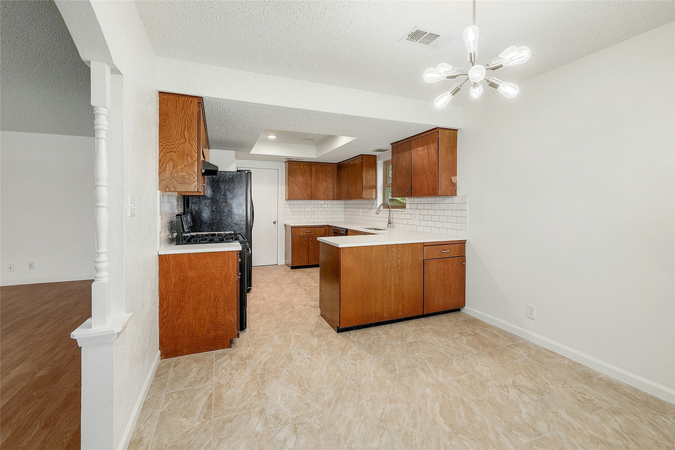 11720 Running Fox Trail Austin, TX 78759 - Photo 12 of 31 a kitchen with stainless steel appliances granite countertop a stove refrigerator a sink dishwasher with wooden cabinets and floor