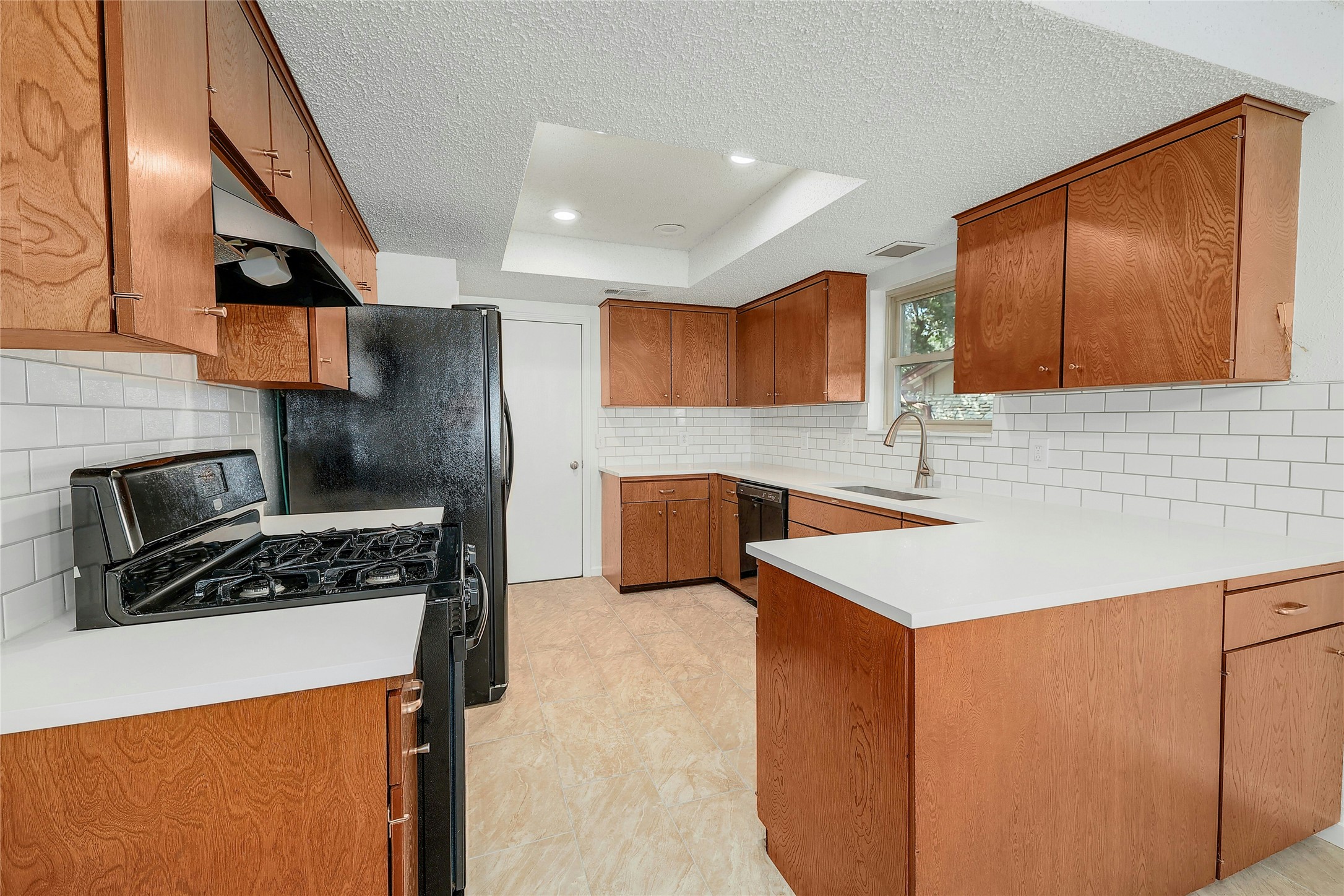 11720 Running Fox Trail Austin, TX 78759 - Photo 13 of 31 a kitchen with stainless steel appliances a stove a sink a refrigerator and a microwave