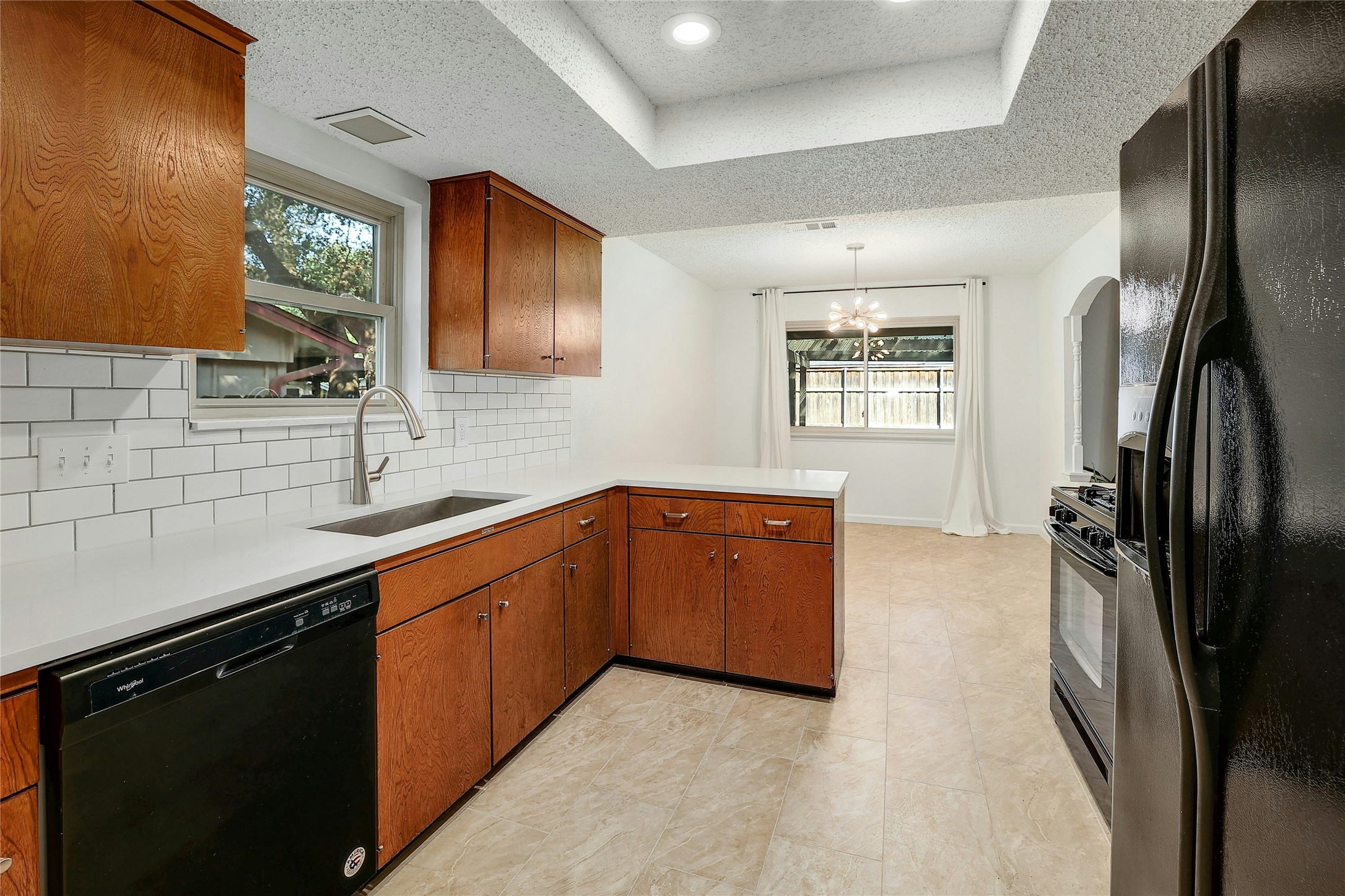 11720 Running Fox Trail Austin, TX 78759 - Photo 14 of 31 a kitchen with stainless steel appliances granite countertop a refrigerator a sink a stove and island