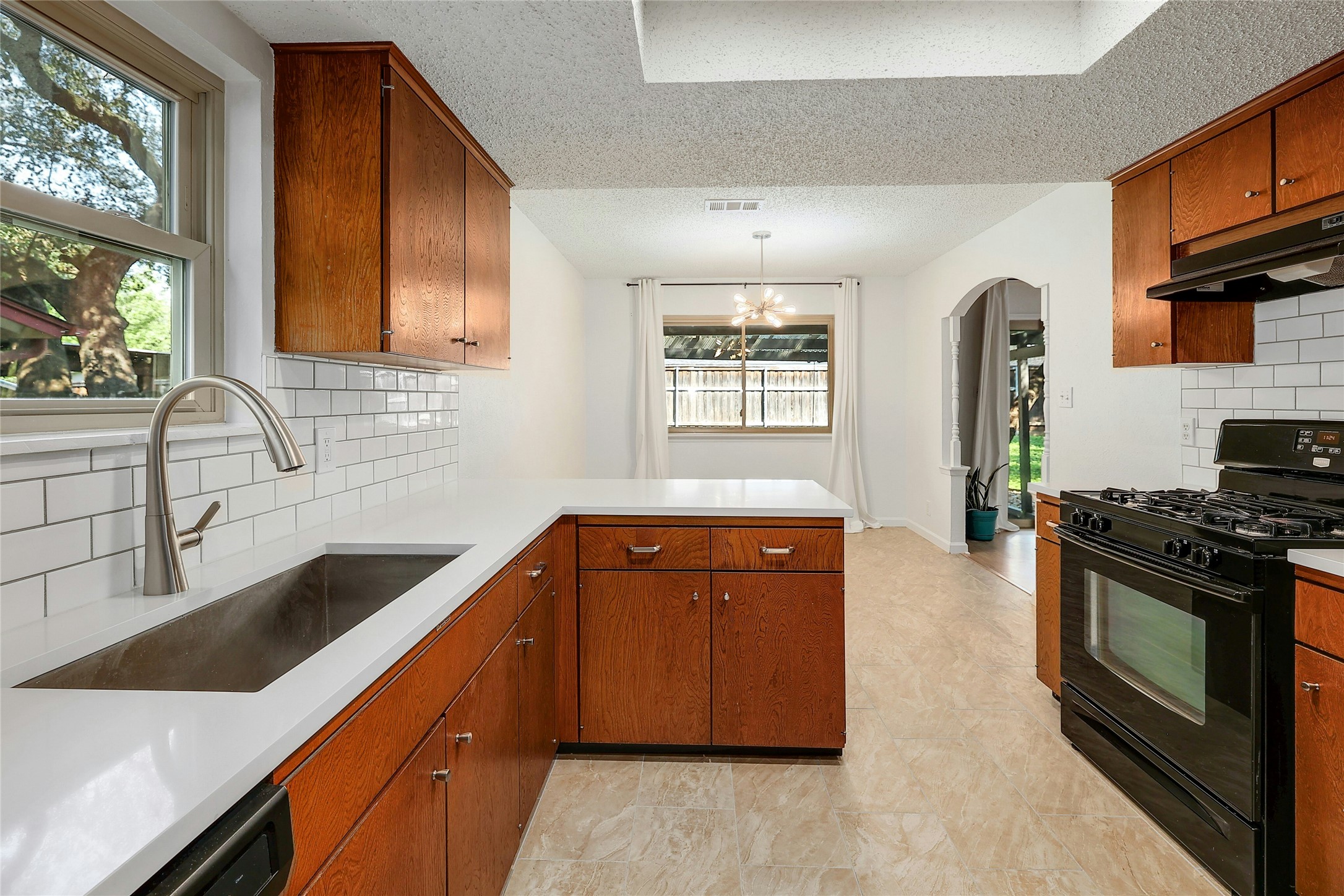 11720 Running Fox Trail Austin, TX 78759 - Photo 16 of 31 a kitchen with stainless steel appliances granite countertop a sink stove and refrigerator