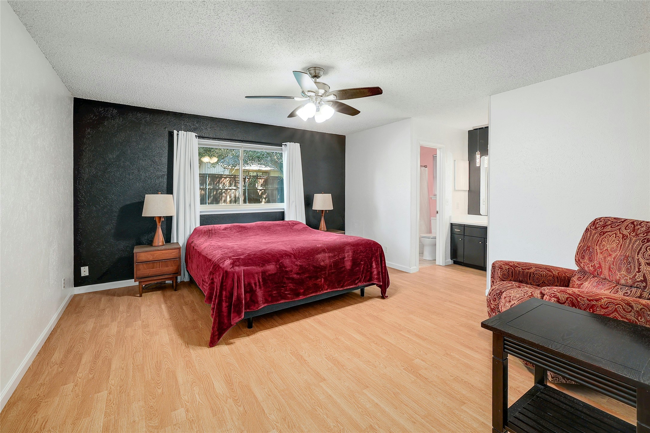 11720 Running Fox Trail Austin, TX 78759 - Photo 17 of 31 a bedroom with a bed and window