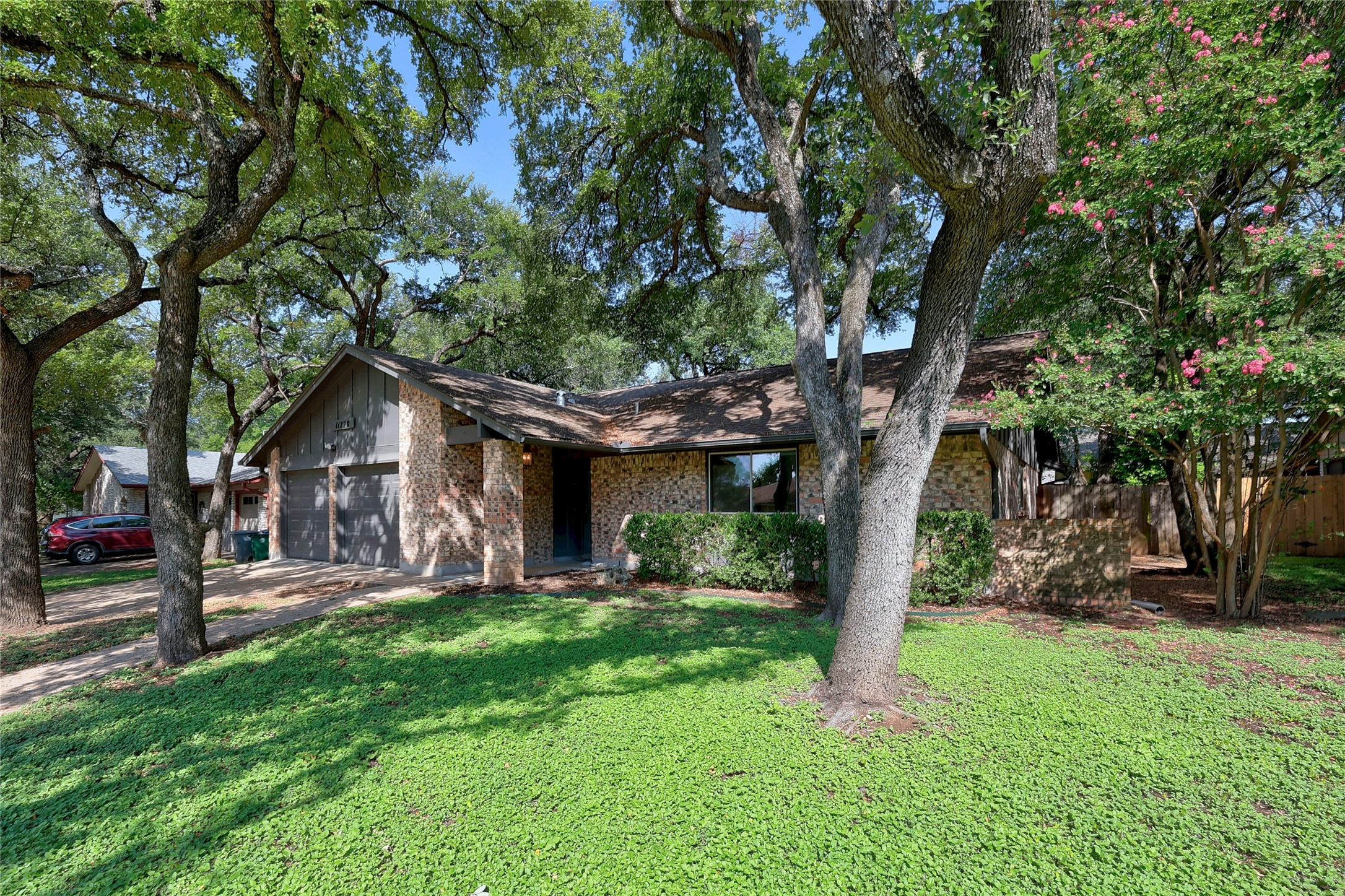11720 Running Fox Trail Austin, TX 78759 - Photo 2 of 31 a front view of house with a garden