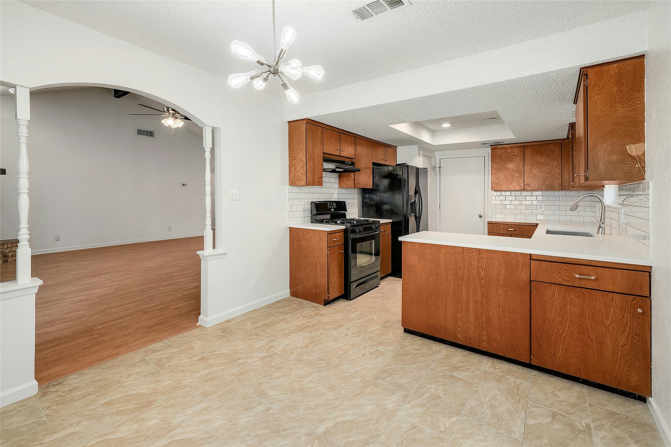 11720 Running Fox Trail Austin, TX 78759 - Photo 8 of 31 a kitchen with stainless steel appliances granite countertop a sink cabinets and wooden floor