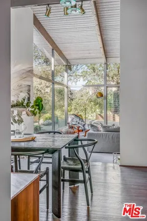 a view of a dining room with furniture window and wooden floor