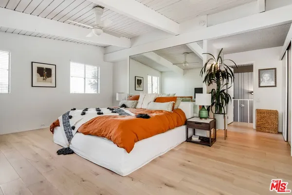 a bed room with a bed and wooden floor