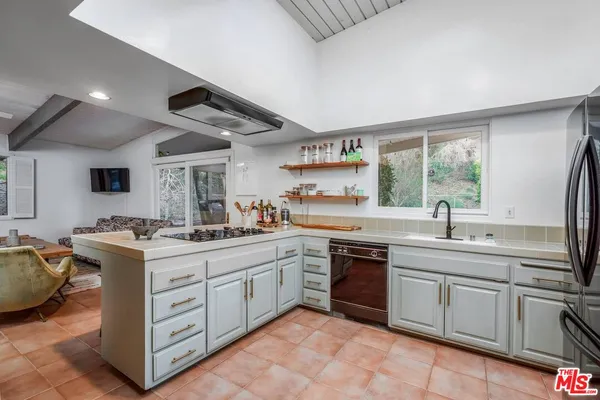 a kitchen with a sink stove and cabinets