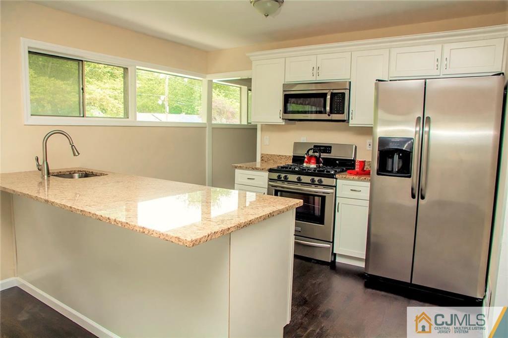 5 Brandeis Road Old Bridge, NJ 08859 - Photo 3 of 25 a kitchen with a sink stove and microwave