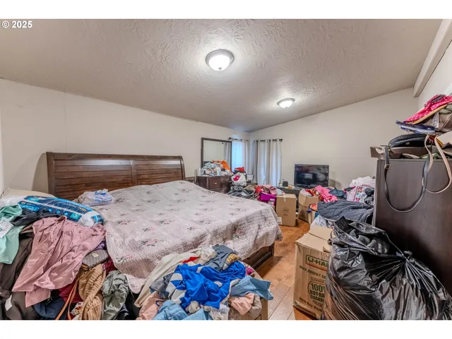 a bedroom with furniture and a flat screen tv