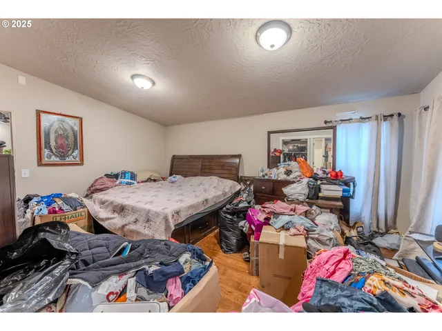 a bedroom with furniture and a flat screen tv