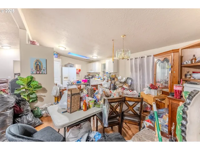 a view of a dining room with furniture and a potted plant