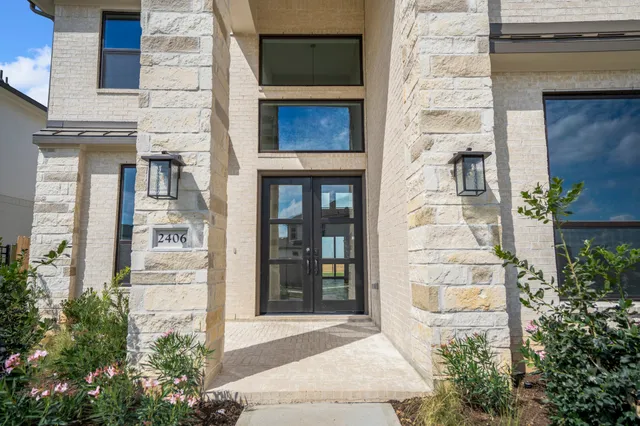a front view of a house with a garden