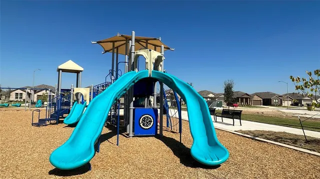a swimming pool with lots of tress in front of it