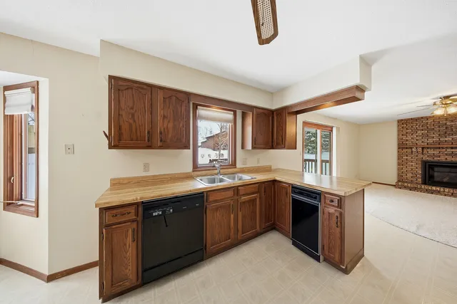 a kitchen with a sink a stove and cabinets