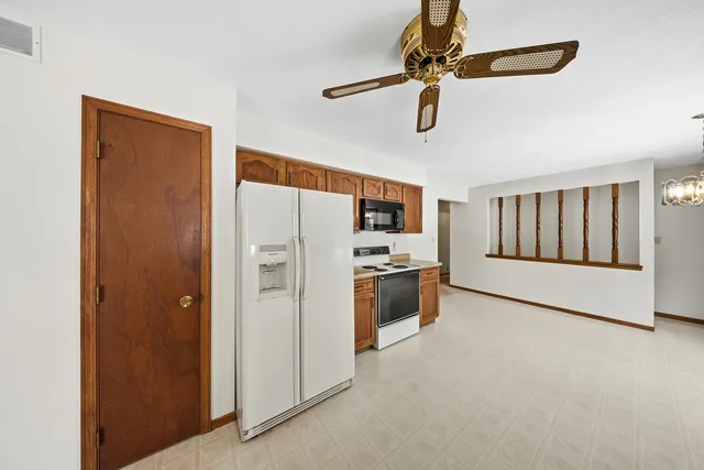 a view of a kitchen with a sink cabinet and a ceiling fan