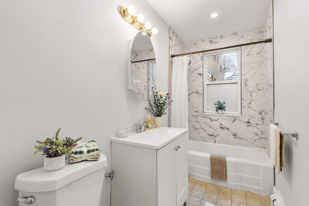 3 Spring Garden Street, Unit 1 Boston, MA 02125 - Photo 7 of 23 a bathroom with a sink mirror and toilet