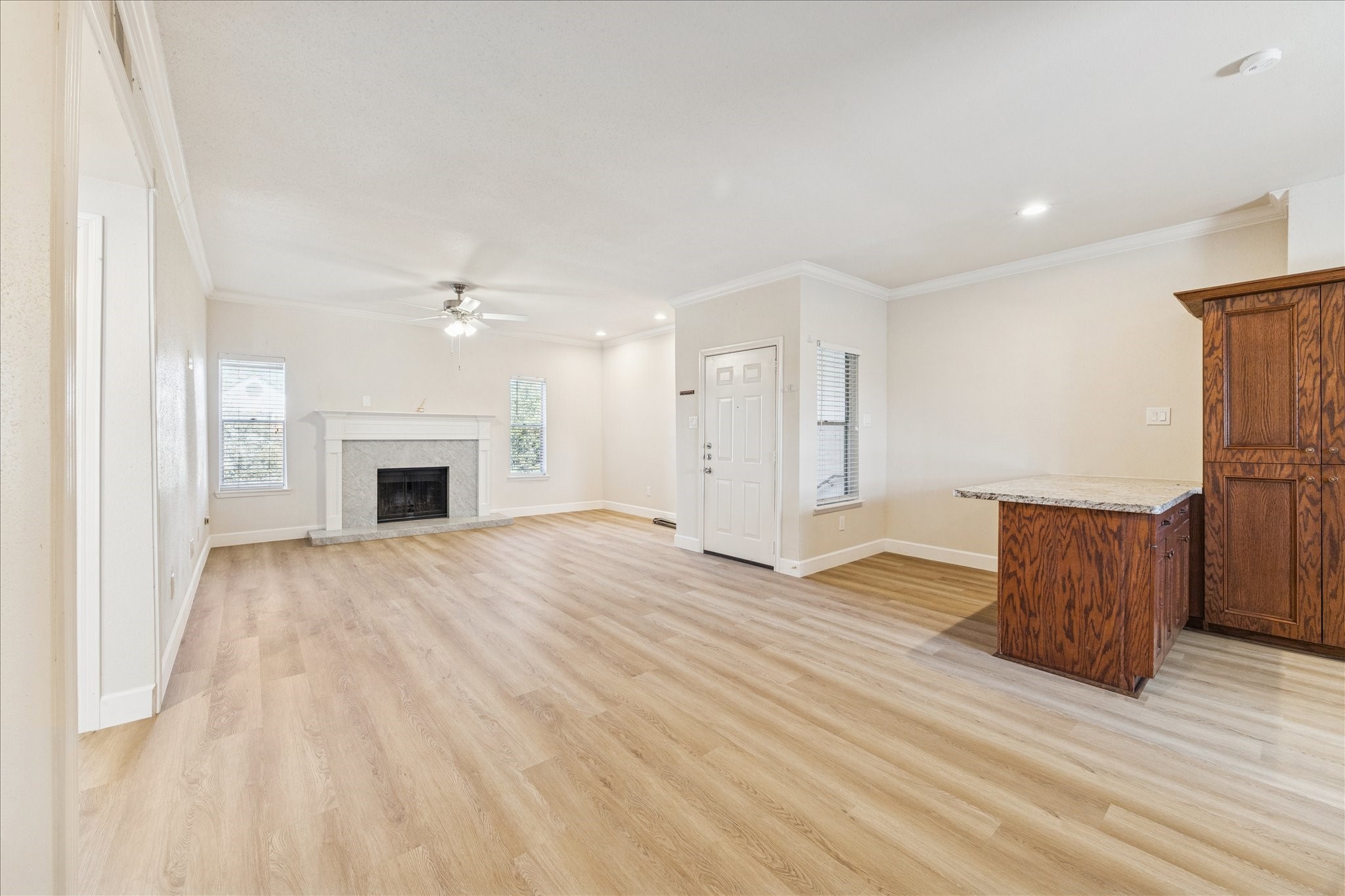 4041 Law Street, Unit 512 Houston, TX 77005 - Photo 4 of 14 a view of empty room with wooden floor and fireplace