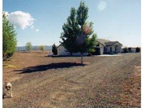 9397 East Mountain Vw Road Prescott Valley, AZ 86315 - Photo 3 of 12 a view of a dry yard with a barn
