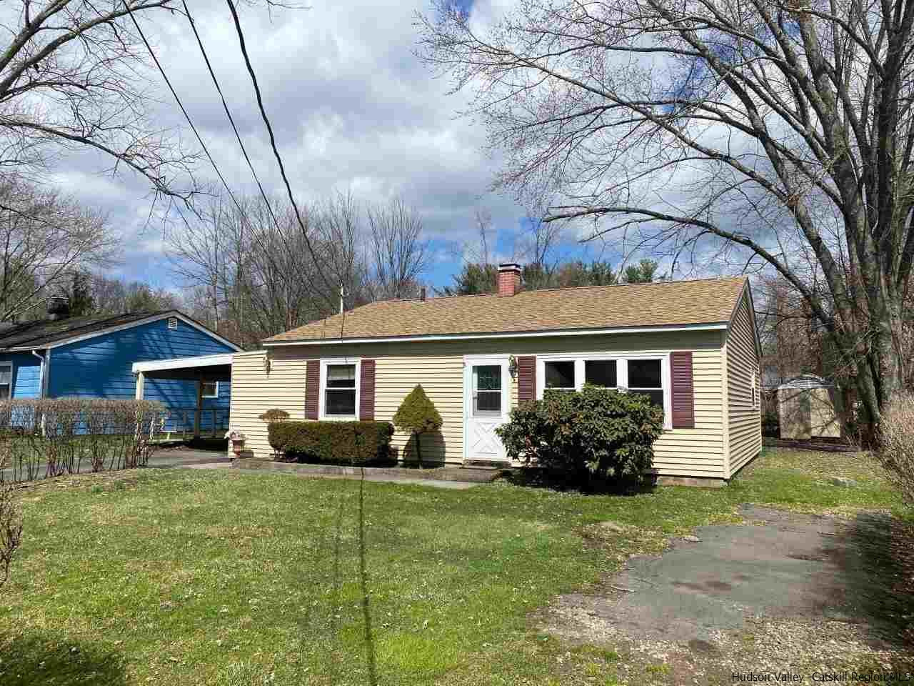 a front view of house with yard and green space