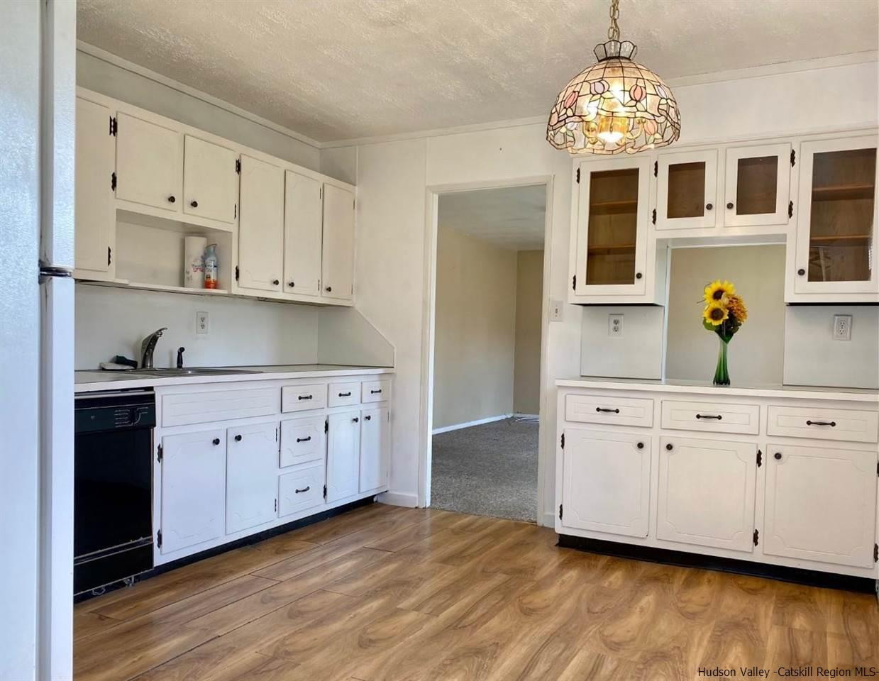5 South Road, Unit HIGH FALLS PARK High Falls, NY 12440 - Photo 3 of 14 a kitchen with granite countertop stainless steel appliances a stove refrigerator and cabinets