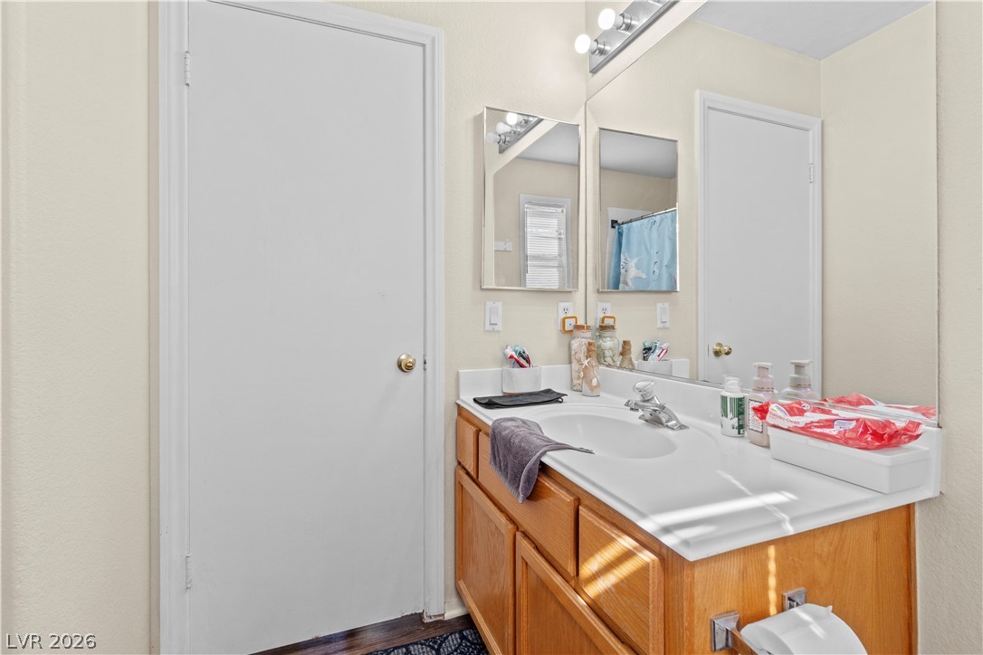 1419 Red Sunset Avenue Henderson, NV 89074 - Photo 25 of 35 Full bathroom featuring vanity and a shower with shower curtain
