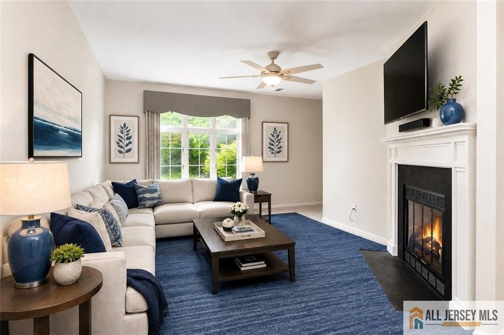 40C Rutland Lane, Unit 40B Monroe Township, NJ 08831 - Photo 4 of 37 a living room with furniture a fireplace and a flat screen tv