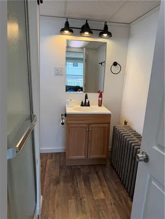 a bathroom with a sink a toilet and mirror