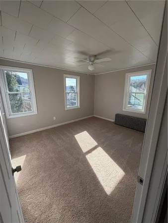 a view of an empty room and a window